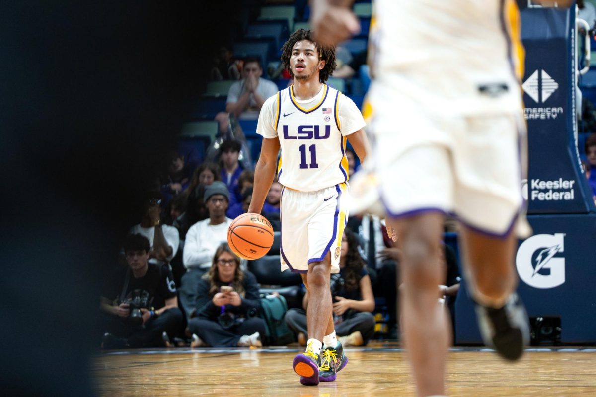 LSU men's basketball junior guard Dedan Thomas Jr. (11) dribbles the ball during the Tigers' 89-77 victory over SMU Saturday, Dec. 13, 2025, at the Smoothie King Center in New Orleans, La.