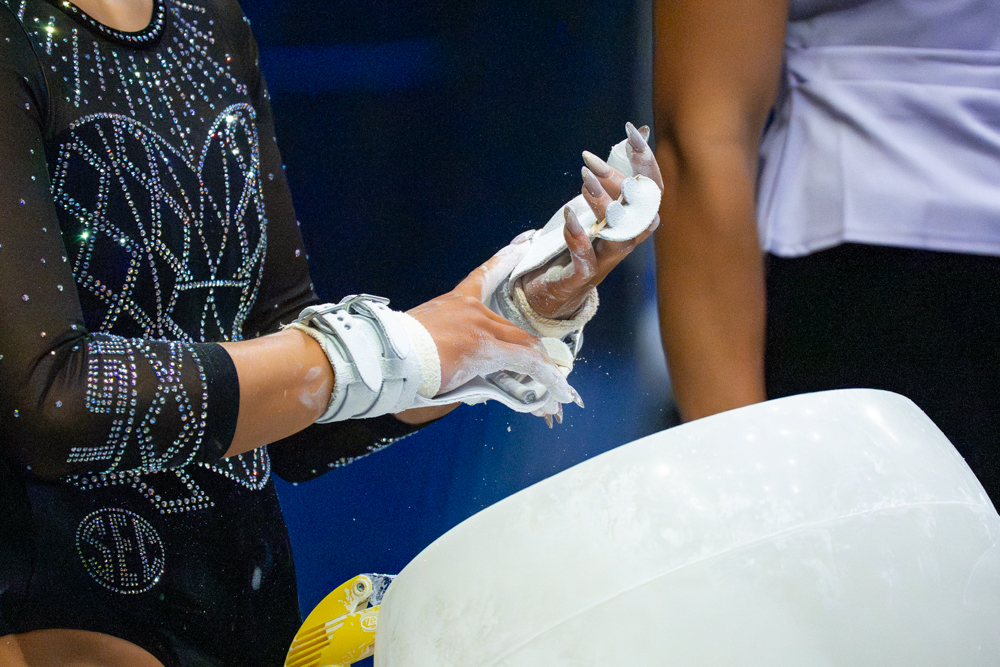 LSU gymnastics all-around sophomore Kailin Chio puts chalk on her hands during the Tigers' 197.825 win Saturday, April 4, 2026, at the Pete Maravich Assembly Center in Baton Rouge, La.