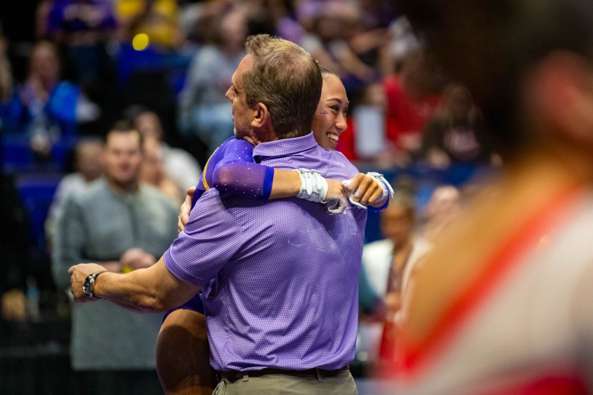 LSU gymnastics sophomore all-around Kailin Chio hugs head coach Jay Clark Thursday, April 2, 2026, during their 198.375 win at the Pete Maravich Assembly Center in Baton Rouge, La.