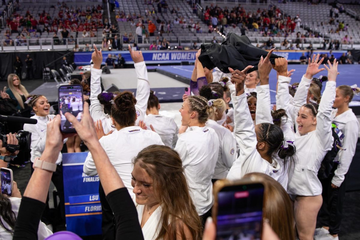 LSU gymnastics teammates celebrate during the Tigers' 197.4375 win Thursday, April 16, 2026, at the Dickies Arena in Fort Worth, Texas.