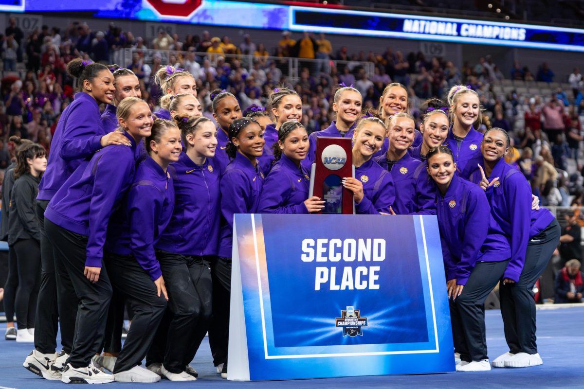 LSU gymnastics teammates pose for a picture during the Tigers' 198.0750 loss Saturday, April 18, 2026, at the Dickies Arena in Fort Worth, Texas.