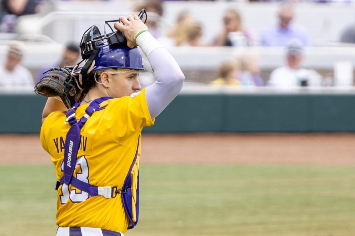 LSU baseball redshirt junior catcher and first baseman Edward Yamin IV (13) puts on a mask during the Tigers' 21-7 victory vs Milwaukee Sunday, Feb. 15, 2026, at Alex Box Stadium in Baton Rouge, La.