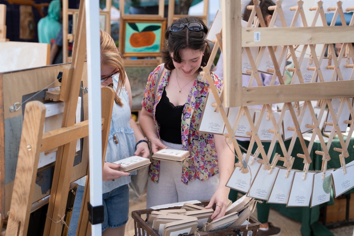 Chloe Trosclair and Brylynn Chasisson looks at products Saturday, July 11, 2026, during Baton Rouge Arts Market at 5th &amp; Main in Baton Rouge, La.
